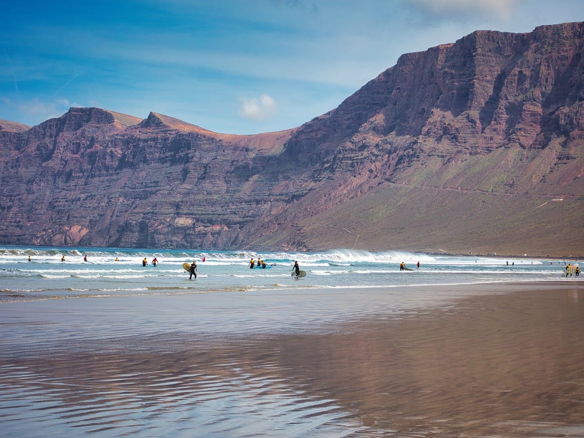 A surf school in the water in Famara, Lanzarote