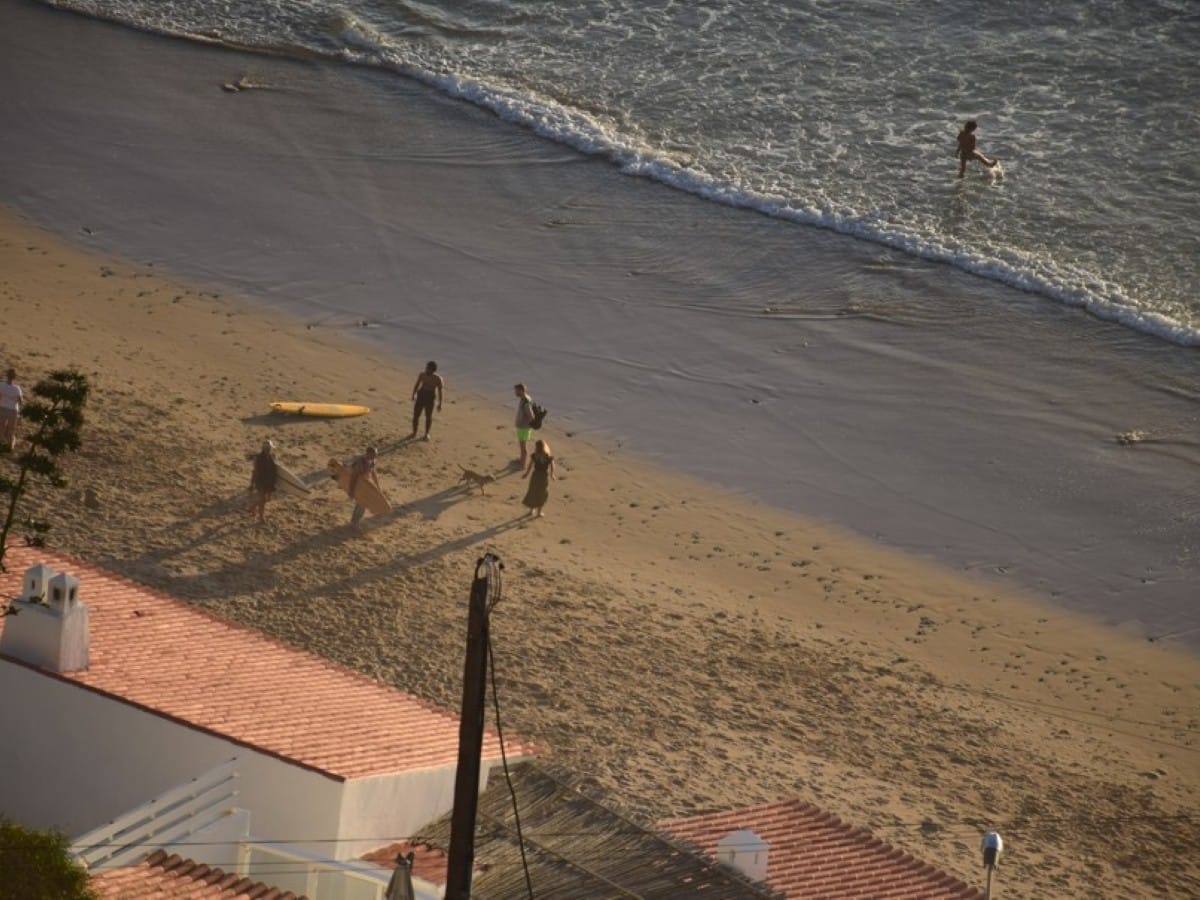 Surfers beside thier beach house in Arrifana, Algarve