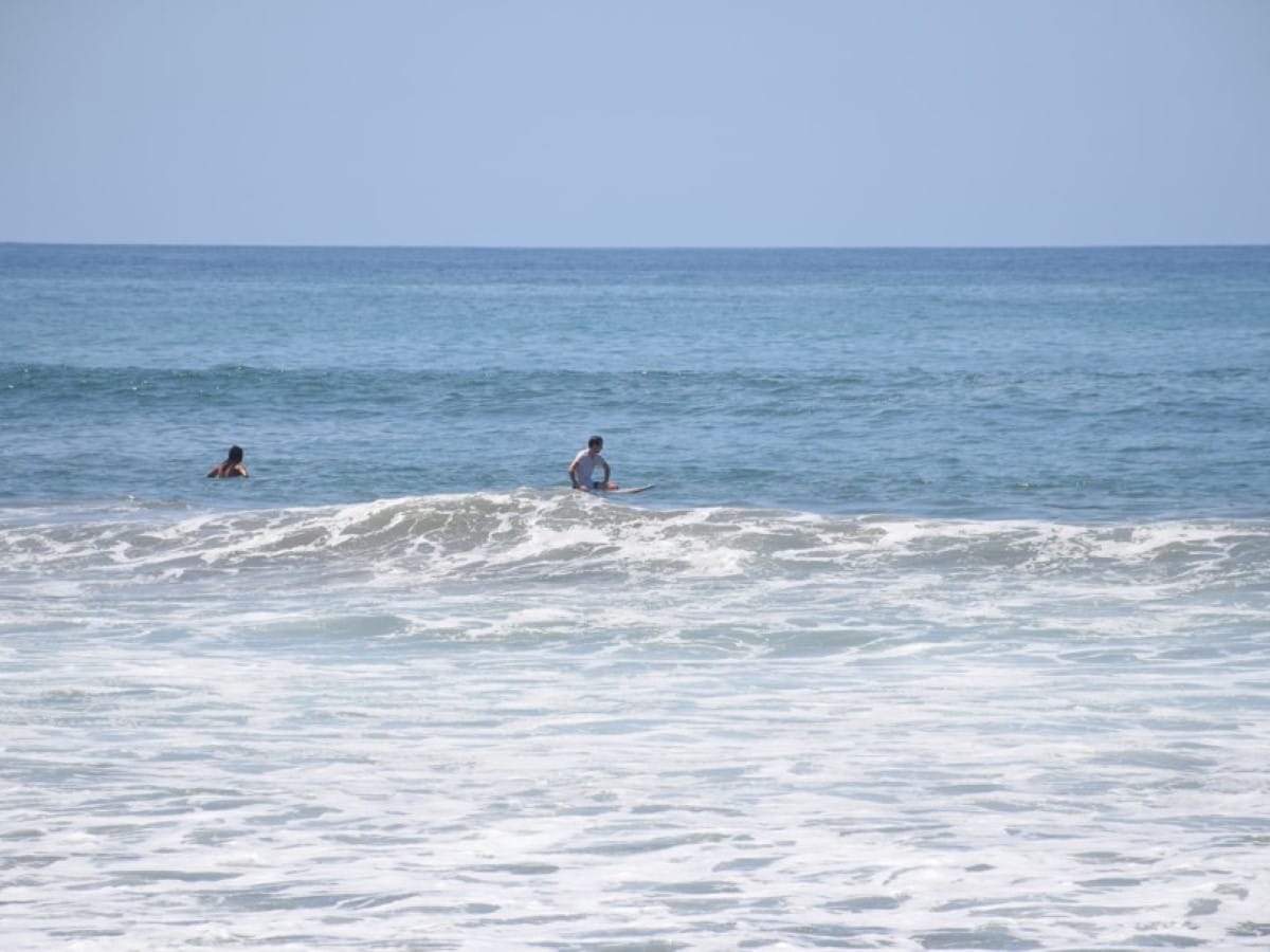 A surfer in the water in San Pancho
