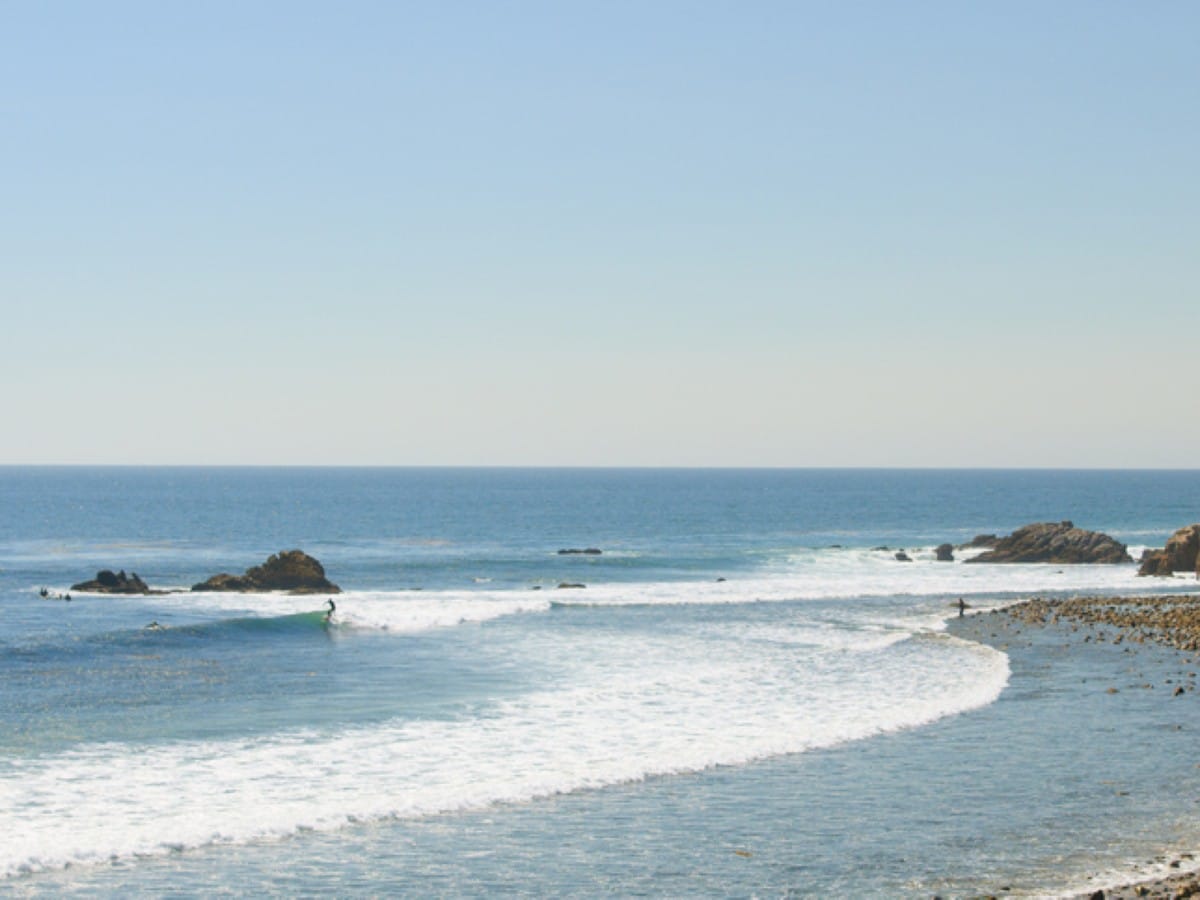A surfer at Leo Carrillo beach in Malibu