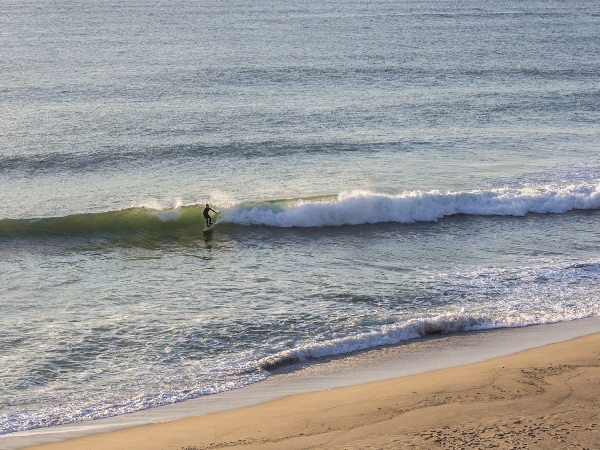 A surfer on a nice summer right in Cape Cod