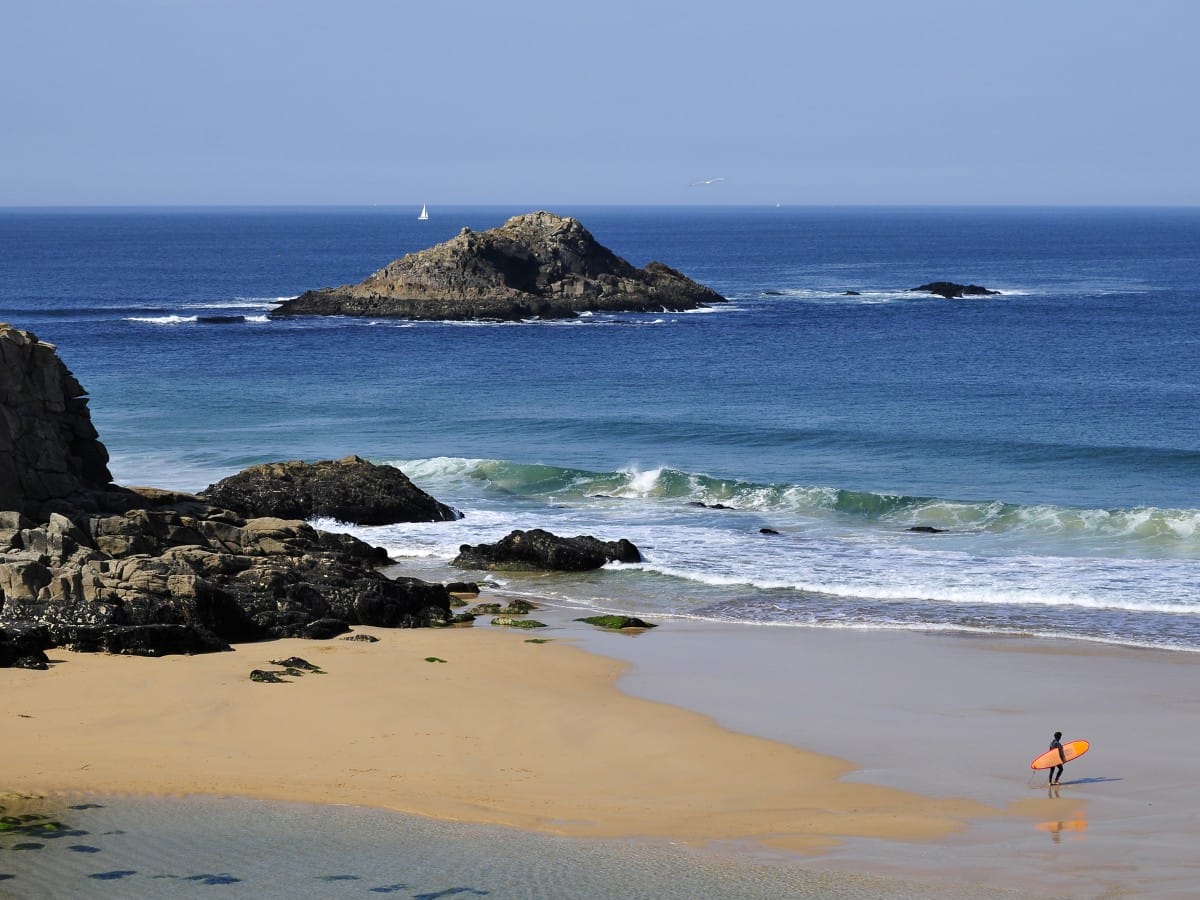 A surfer about to go out at Port Bara