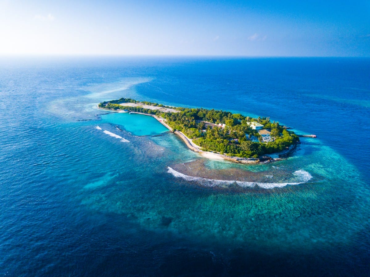 Surf around an island in the Maldives