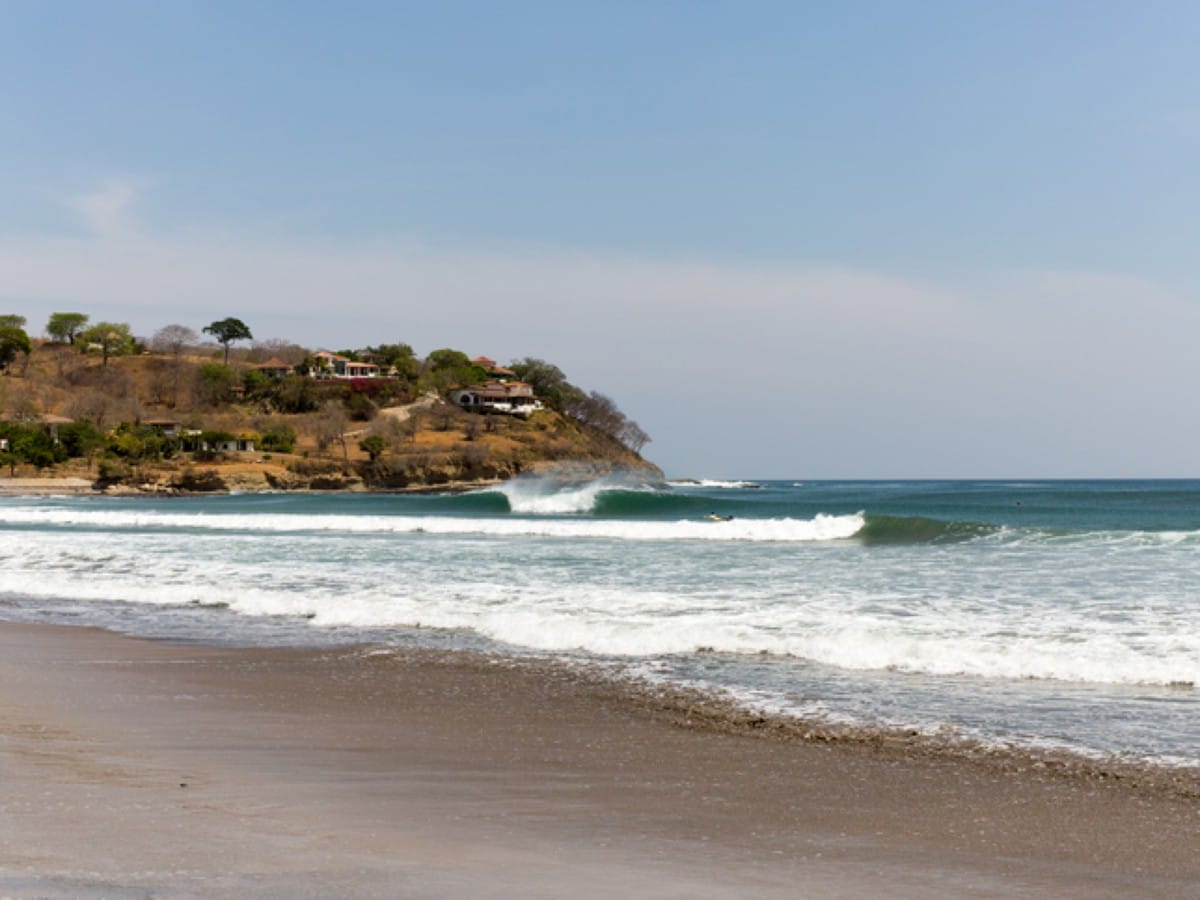 An A-frame wave breaks on a beach in Nicaragua